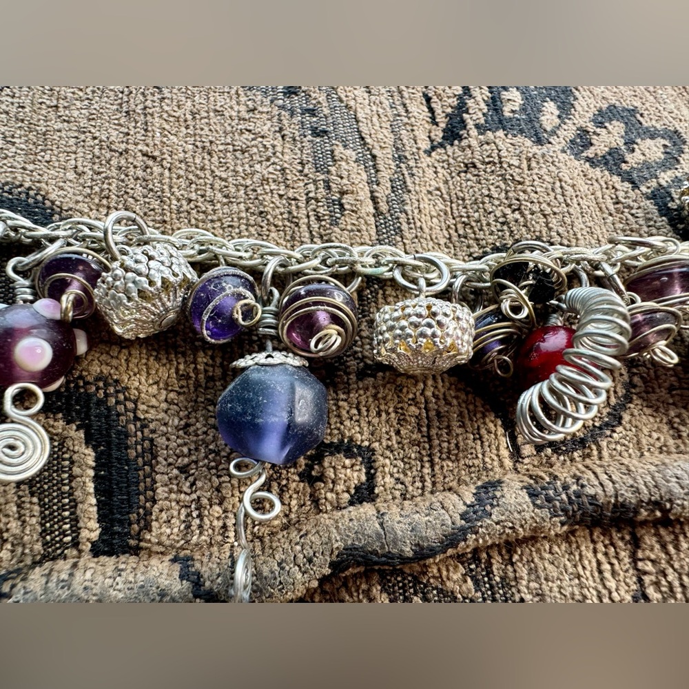 Handcrafted charm brac with glass head charms.
